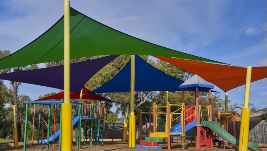 Large shade structure over a school playground in Kenya with children playing