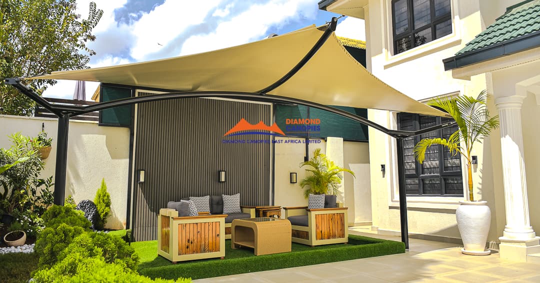 Tensile sail shade canopy over a lawn courtyard installed by Diamond Canopies