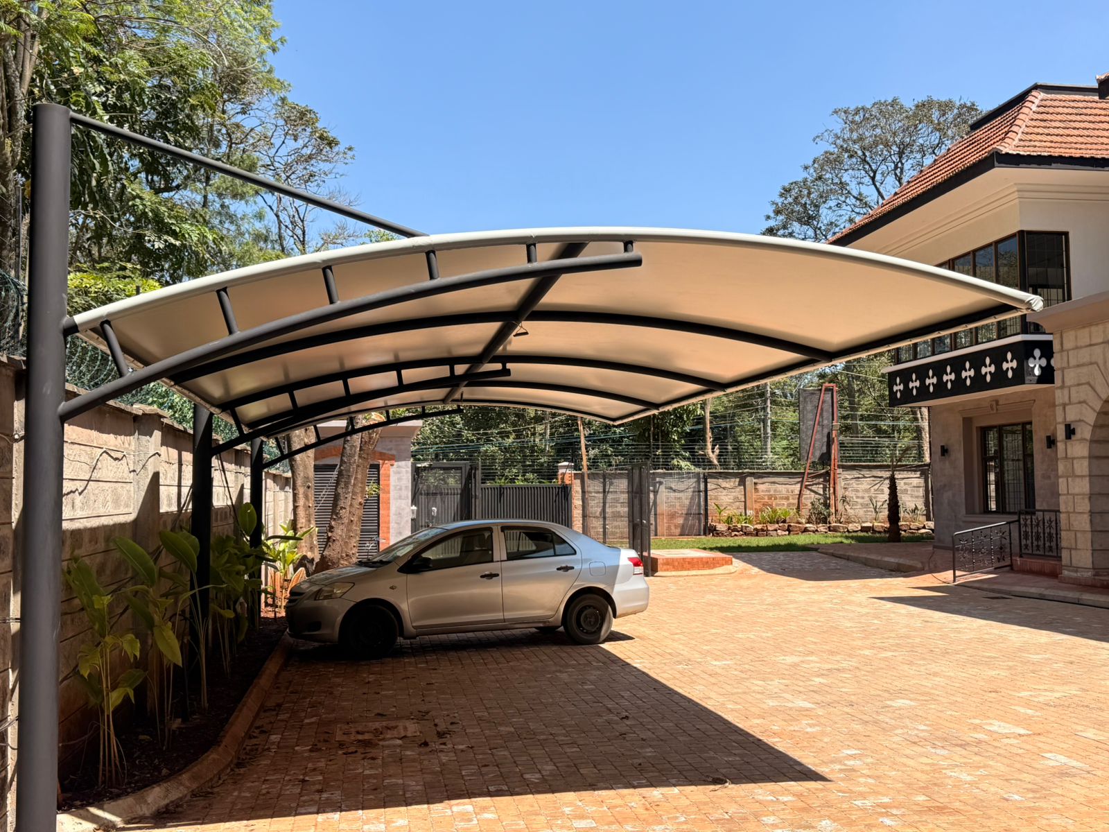 curved car parking shade installation at Mr Priyesh residence